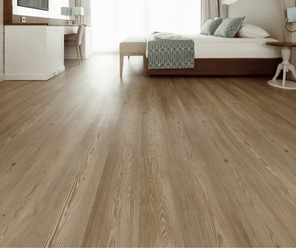 Modern bedroom featuring wooden flooring and a cozy bed