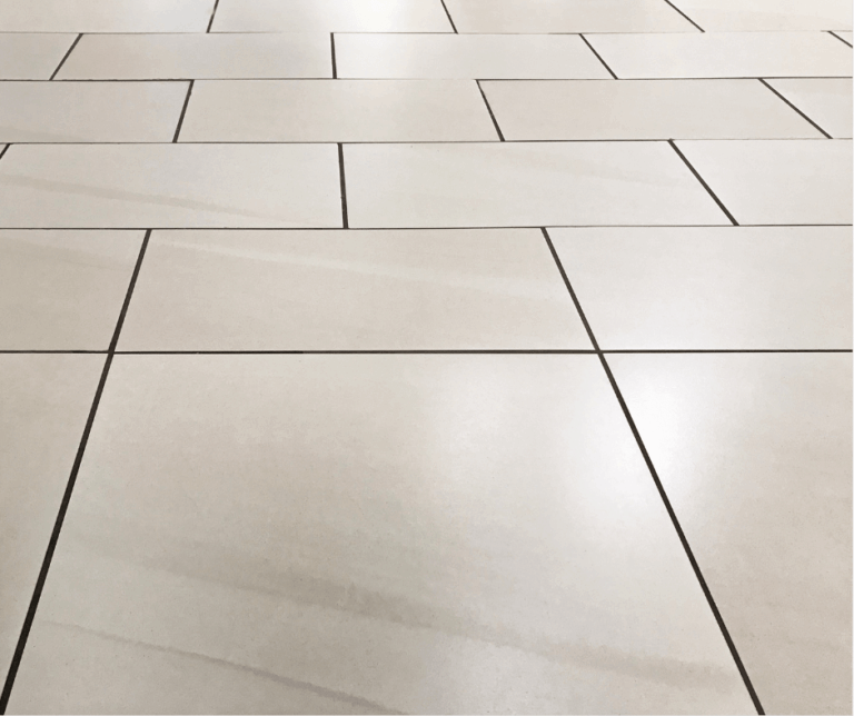 Close-up of a light-colored tiled floor with a geometric pattern